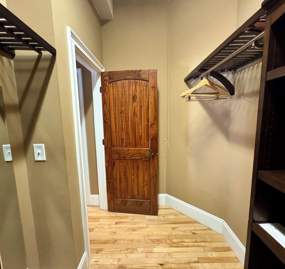 Large walk-in closet with plenty of storage and hangers.