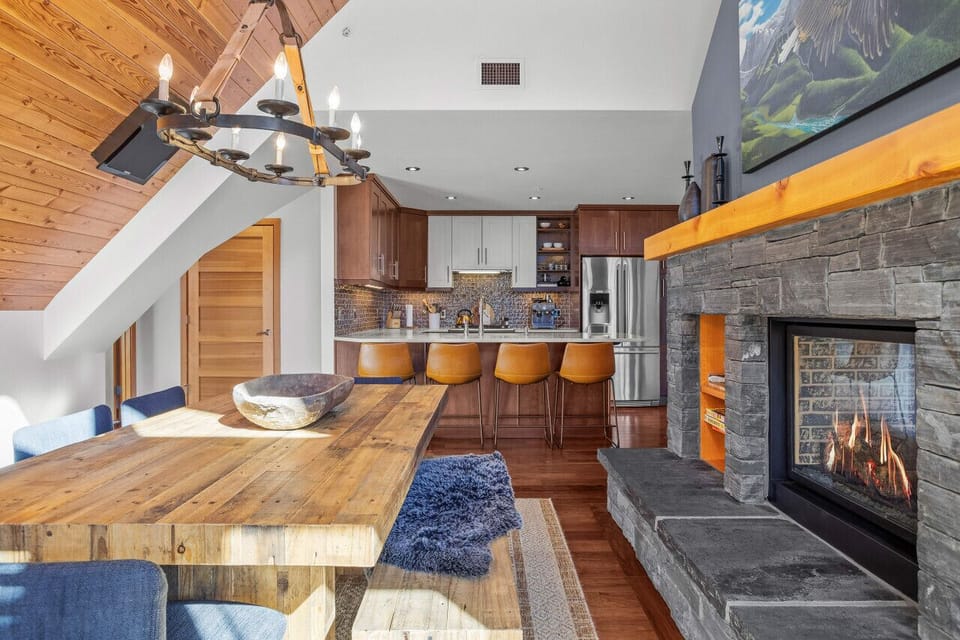 Feel the warmth of the fire on your back as you relax at the dining table