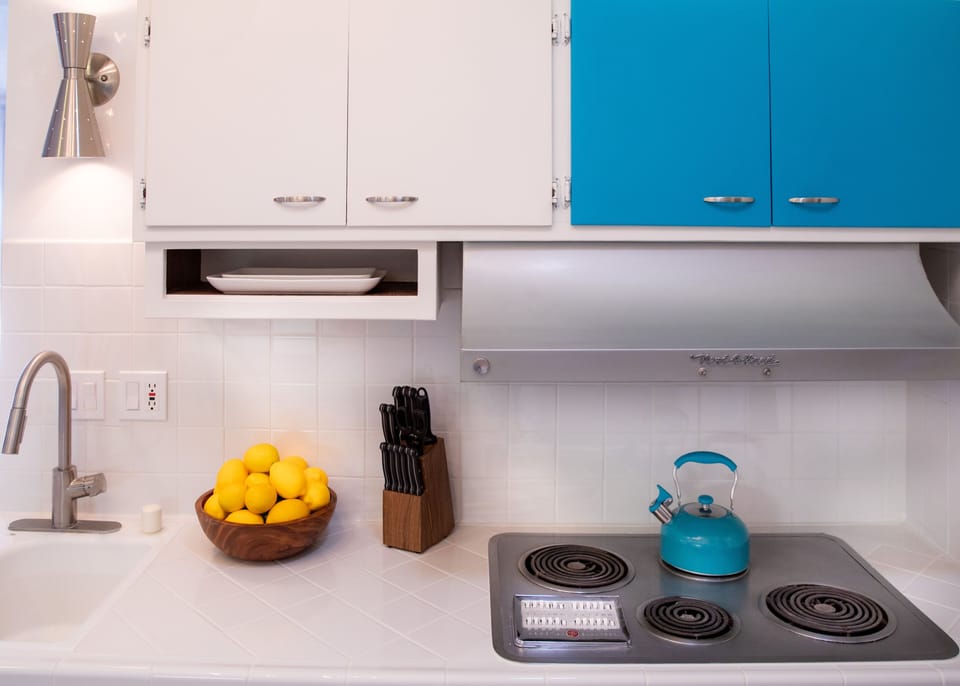 Kitchen with stainless steel appliances & functioning vintage cooktop