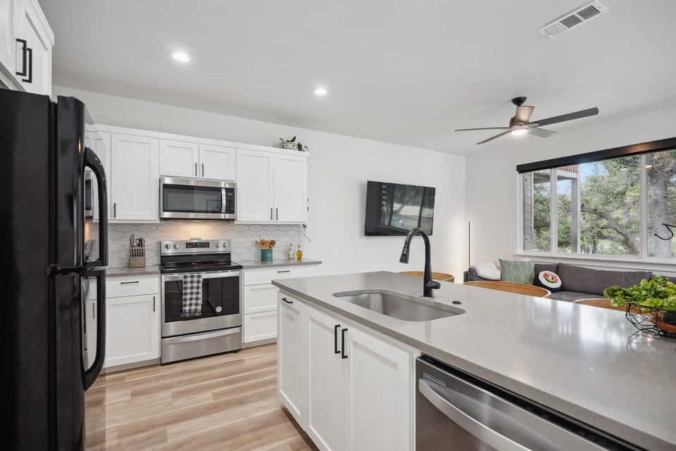 This sleek kitchen features fully equipped appliances, cookware, and dining essentials. Coffee enthusiasts can choose from a traditional coffee maker, a Keurig, or an espresso machine, with pods and supplies provided for the perfect brew.