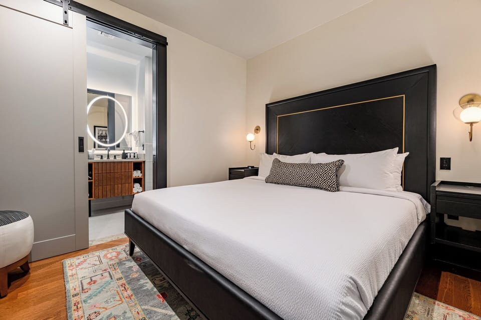 Bedroom 1 - King bed featuring a built-in wardrobe, flat-screen TV, and en-suite bathroom.
