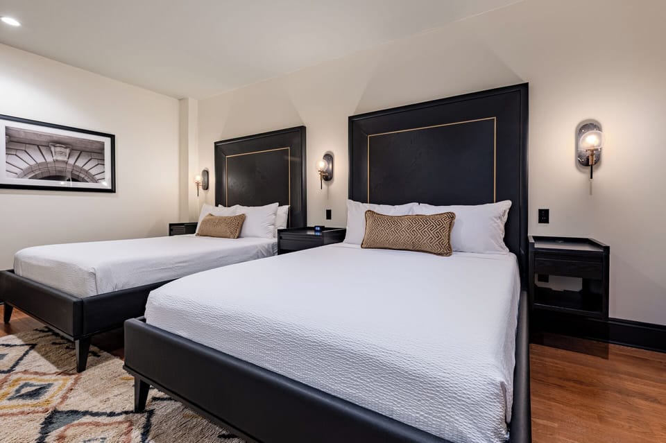 Bedroom 1 - Double queen beds featuring a built-in wardrobe and flat-screen TV.