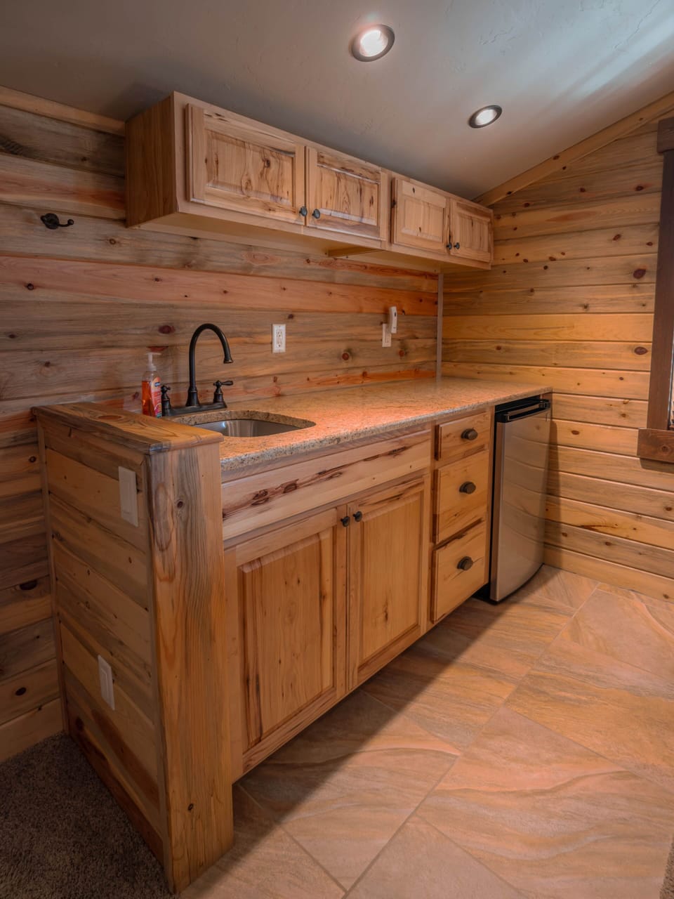 Upstairs kitchenette featuring a sink and mini fridge.