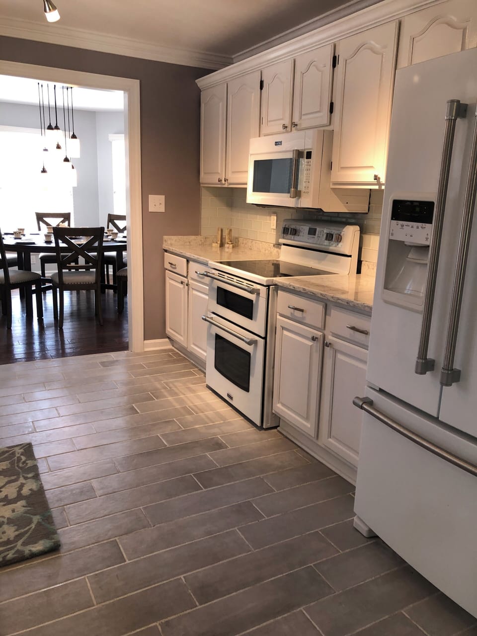 The updated kitchen connects the formal and casual dining areas for seating 18