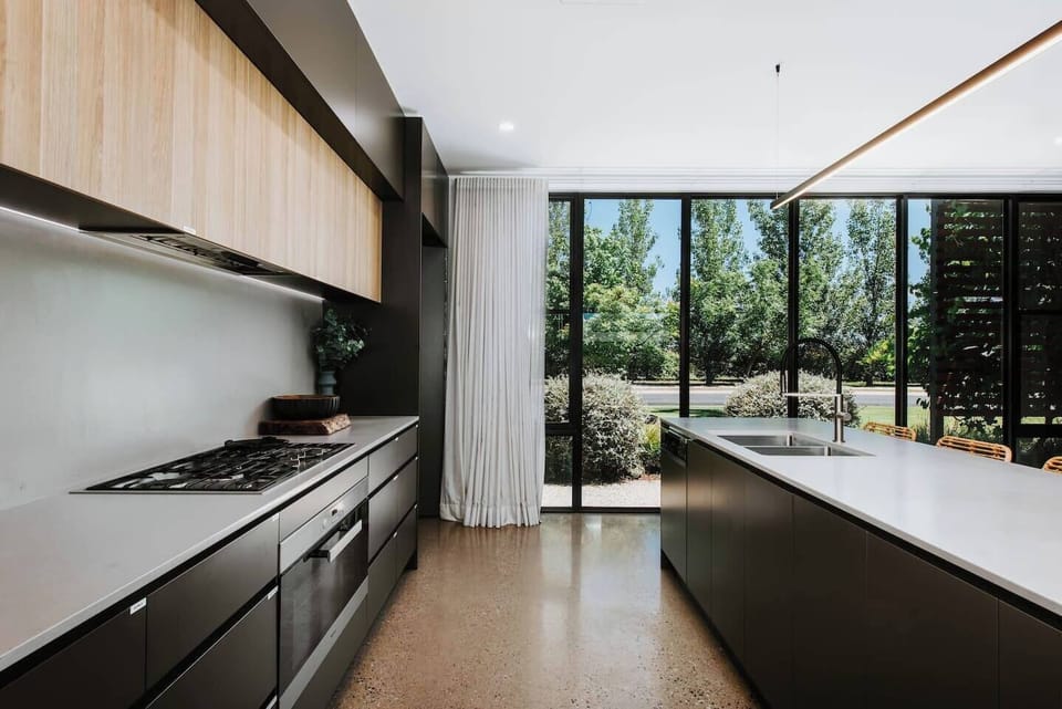 The stunning kitchen comes fully equipped for your holiday catering with sleek appliances and cooking utensils.