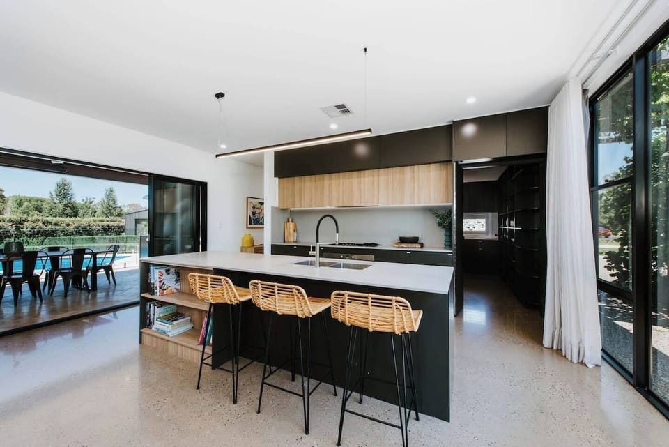 The kitchen is designed around a central island with plenty of space to prepare meals and come together.