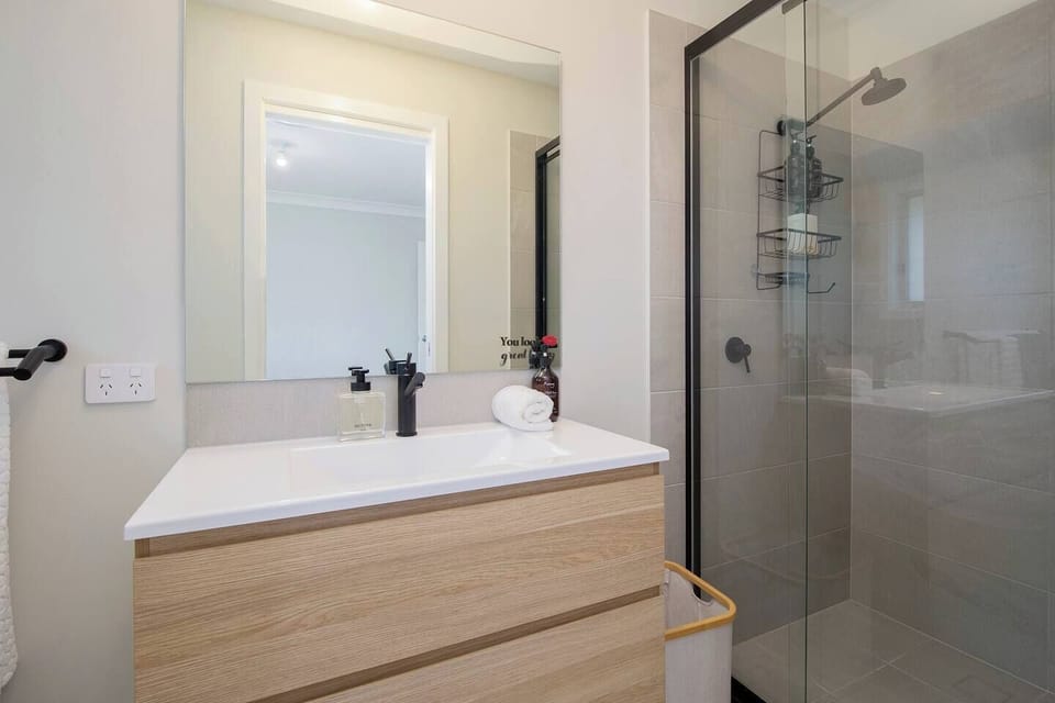 The second-bedroom ensuite comes complete with an enclosed shower, vanity and toilet. 