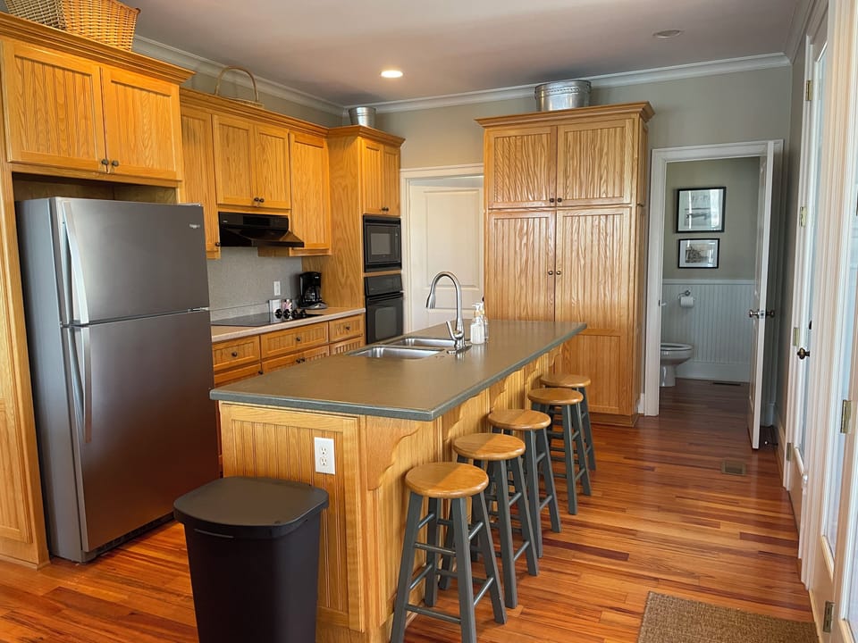 Kitchen with ample storage and stools for five