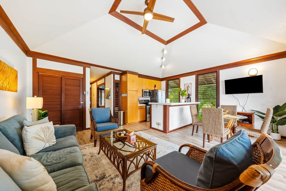 Step into this stunning living space where modern design meets tropical charm