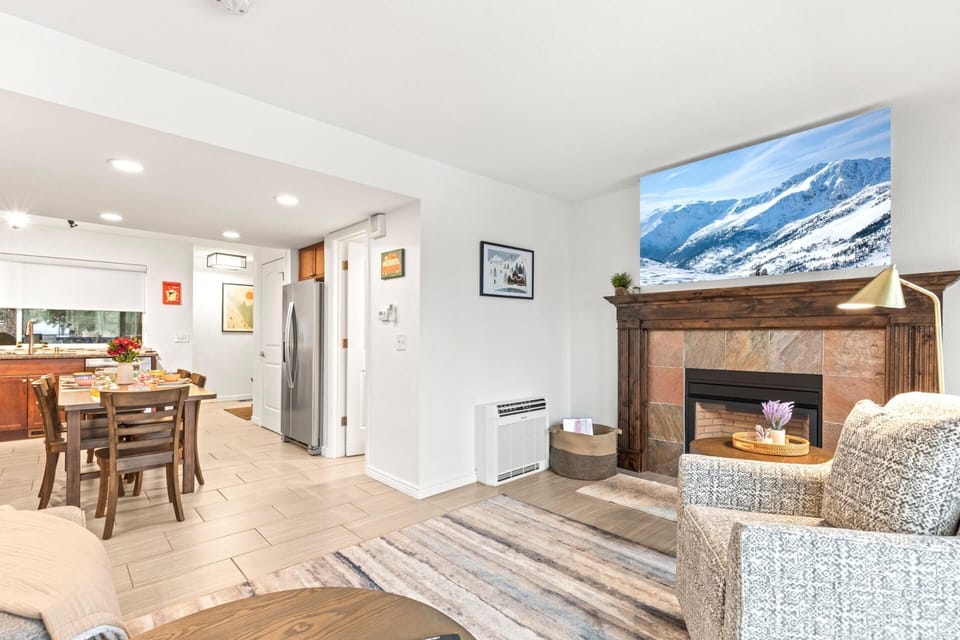    Cozy home warmth with scenic snowy mountain fireplace view.