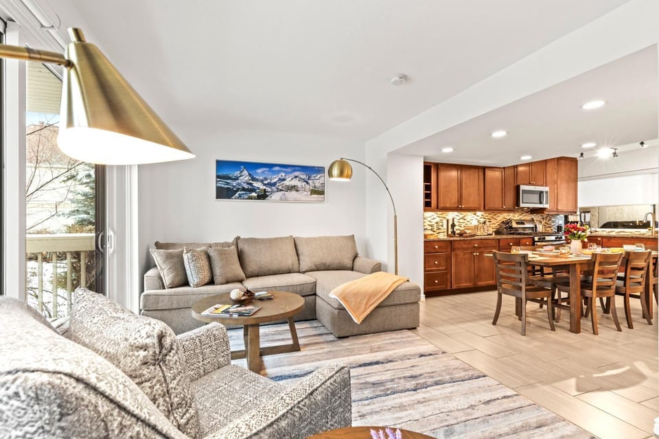 Bright open living space with cozy seating and modern kitchen. RCT-42