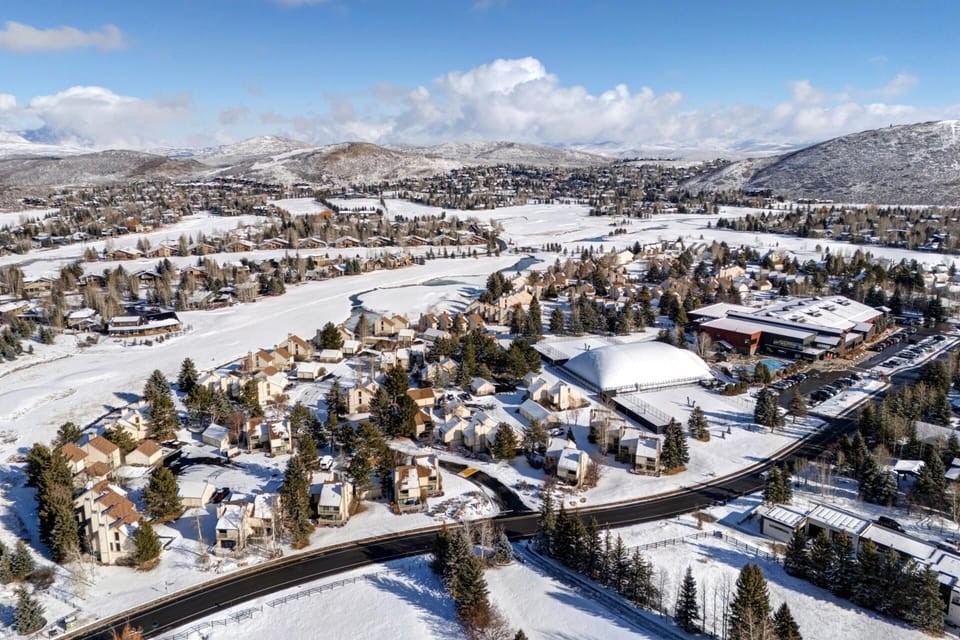 Expansive snowy neighborhood view surrounded by hills and clear sky. RCT-42
