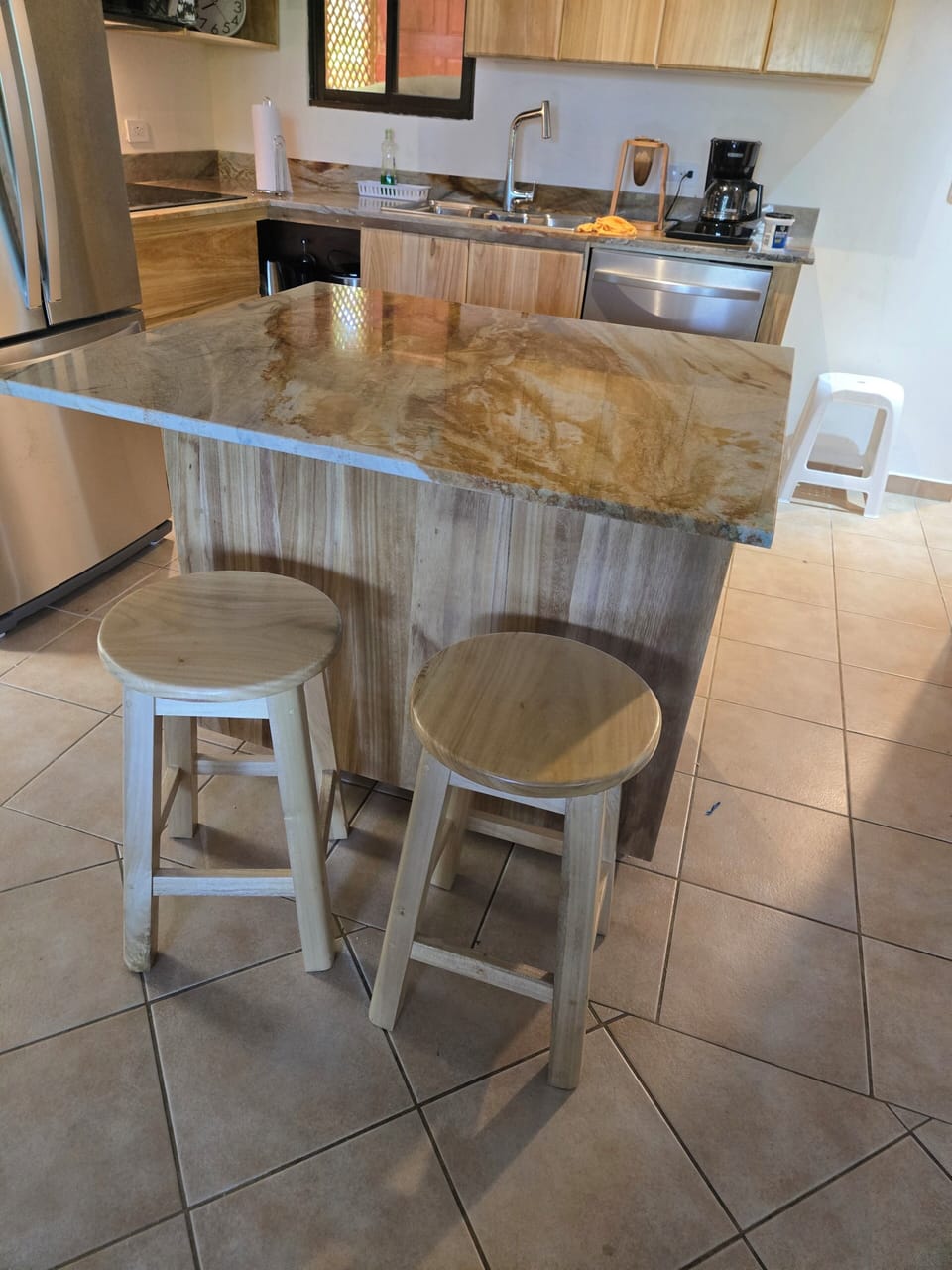 Kitchen Island is on casters,  position where you want. Make sure to lock caster