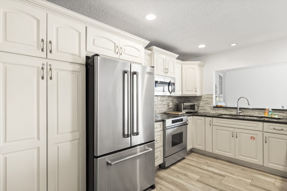Fully equipped kitchen with stainless steel appliances, granite countertops, and everything needed for home-cooked meals.