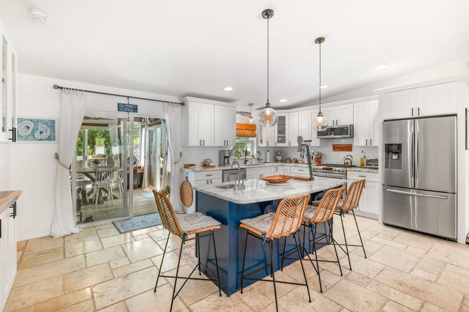 The kitchen features granite countertops, a gas cooktop + new appliances!