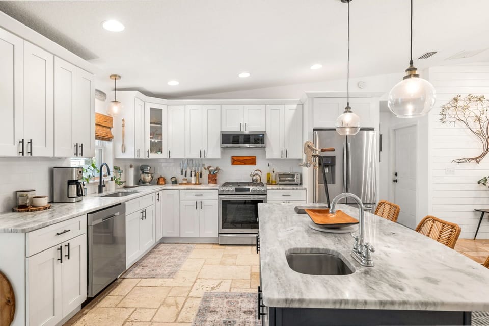 This modern kitchen offers plenty of counter space and a breakfast island for casual dining!