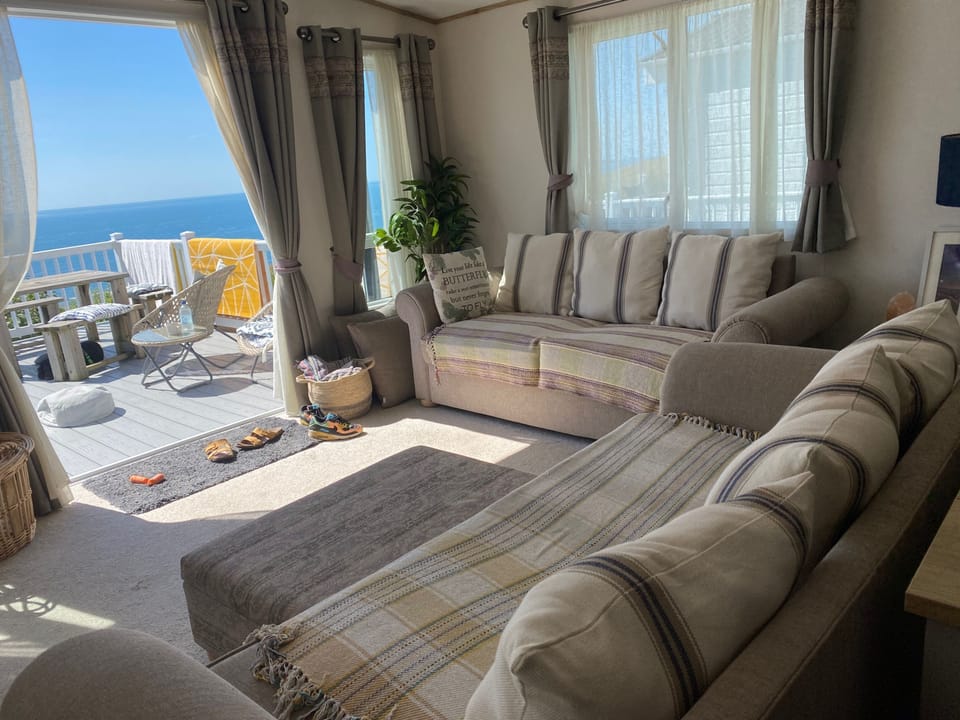 Open plan kitchen and living space out on to seaview balcony with views across the Dorset Coast, Lulworth Cove & Durdle Door