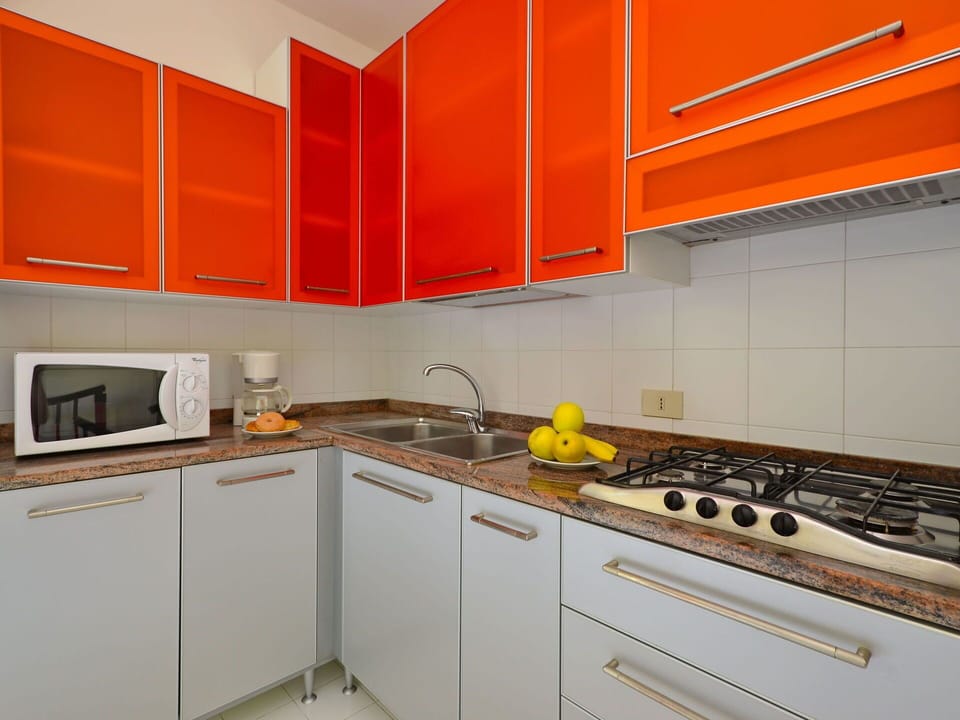 Kitchen, Kitchen Appliance, Countertop, Major Appliance, Cabinetry, Kitchen Sink, Wood, Flooring, Interior Design, Orange