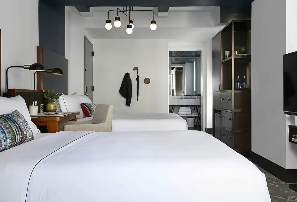 Recharge in a sleek double-queen setup with thoughtful details.