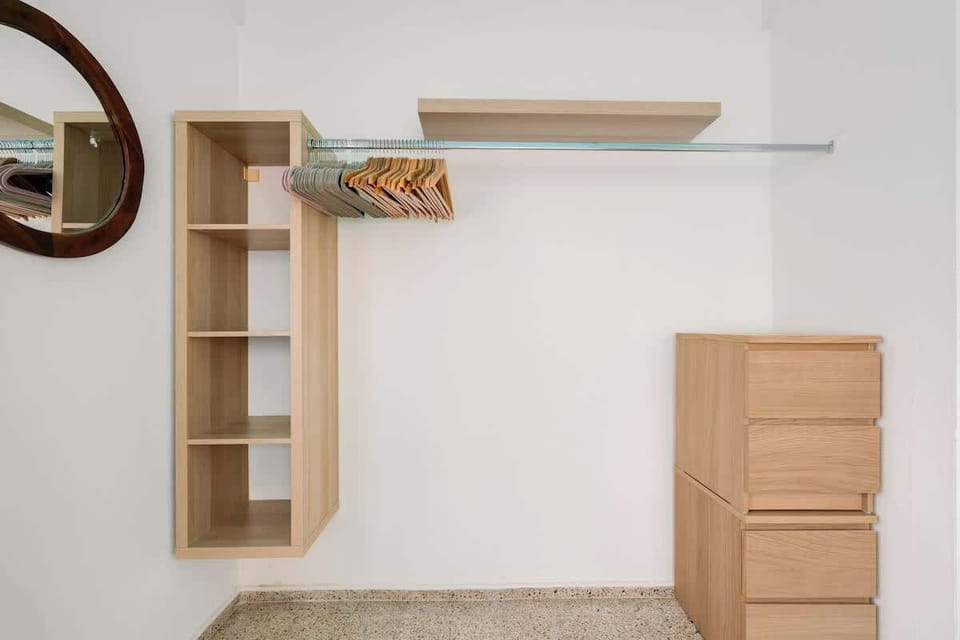 An open, minimalist closet offering ample storage for all your essentials.