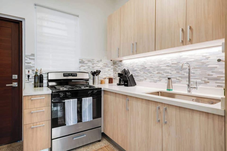 A fully equipped kitchen with sleek, modern design, perfect for preparing your favorite meals.