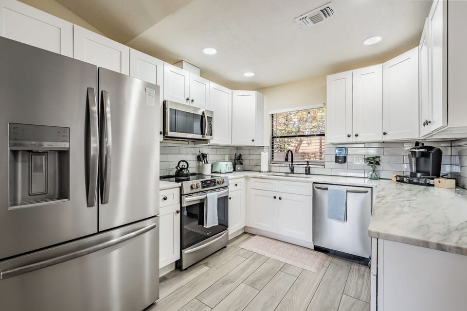 Whip up delicious meals in this fully equipped kitchen with modern stainless steel appliances, pots and pans, spices, cutting boards, Keurig coffee maker and kid-friendly tableware.