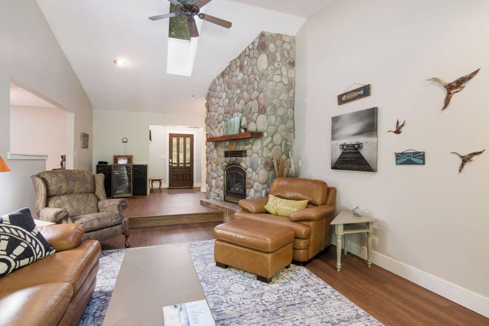 Main living area with gas fireplace, TV, back porch.