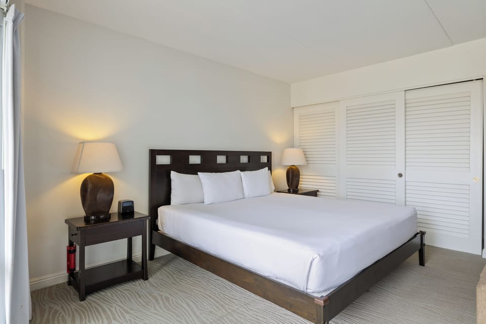 Relax in your serene bedroom with a plush king bed, warm ambient lighting, and spacious built-in closets for all your belongings.