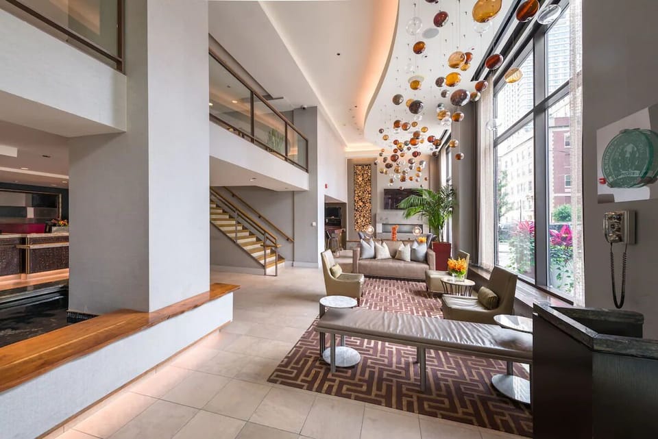 Settle into plush sofas beside sunlit windows and city views