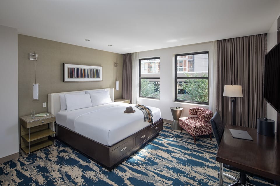 Stretch out in a spacious room with lounge chair and light.