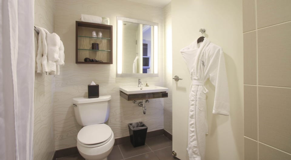 Freshen up in a spotless bath with plush robes provided.
