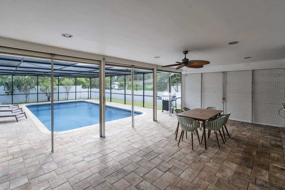 Covered patio, screened pool, and sunny comfort 🌞 This South Florida vacation rental offers outdoor dining, lounge chairs, and insect-free swimming—perfect for families, groups, or long-term stays. Book your relaxing escape today!