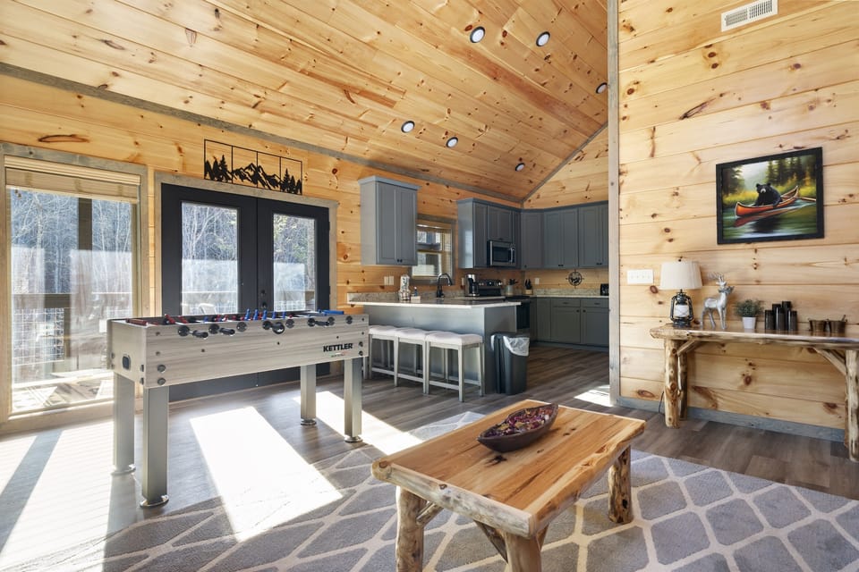 Game room + kitchenette vibes—foosball front and center with extra seating for the whole crew. Great place for snacks, board games, and rainy-day fun when you still want everyone together (without being on top of each other).