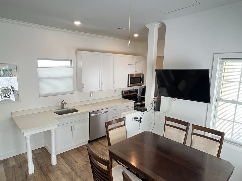 Bright and open kitchen and dining area, perfect for cooking meals and gathering around the table. Enjoy all the comforts of home with plenty of space to dine and relax.