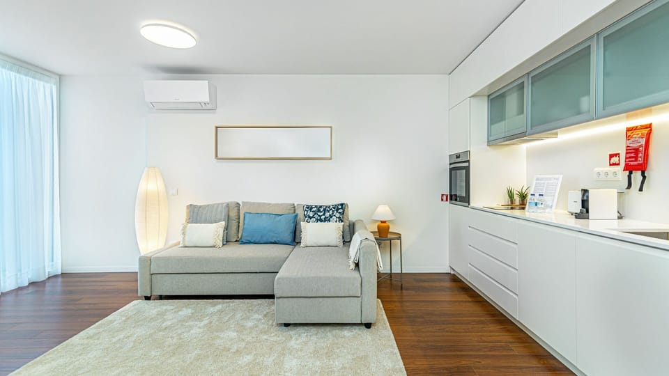 Bright and airy living area with comfortable seating and thoughtful design touches. Your home away from home in Portugal! #Modern #Airbnb