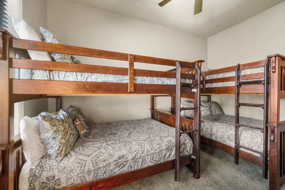 Recharge in the second bedroom retreat, featuring a full double bunk bed and a queen bed