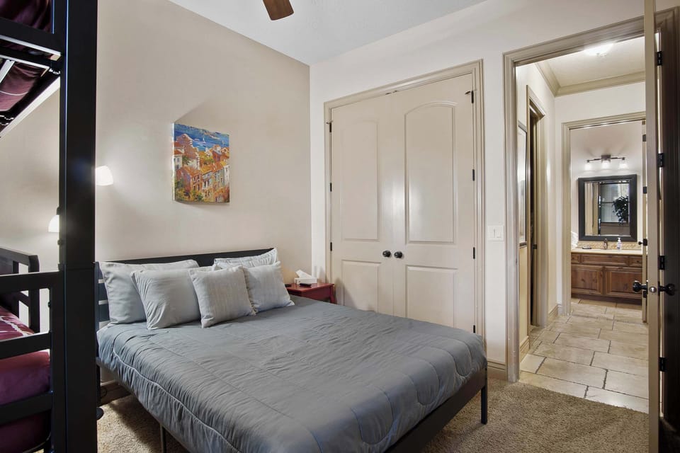 Queen sized bed, triple twin bunks, and smart tv
