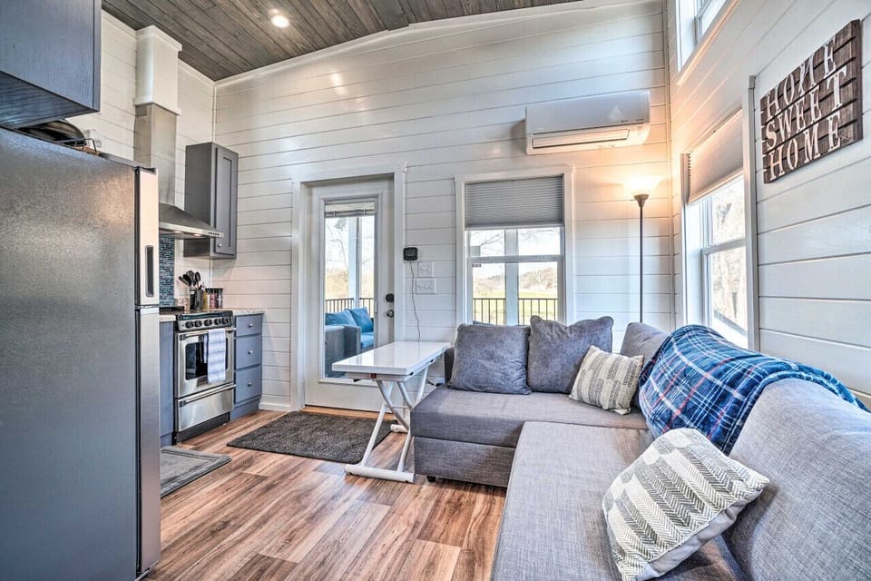 Bright and cozy living area with a comfy sectional, smart TV, and easy access to the porch—perfect for relaxation and downtime