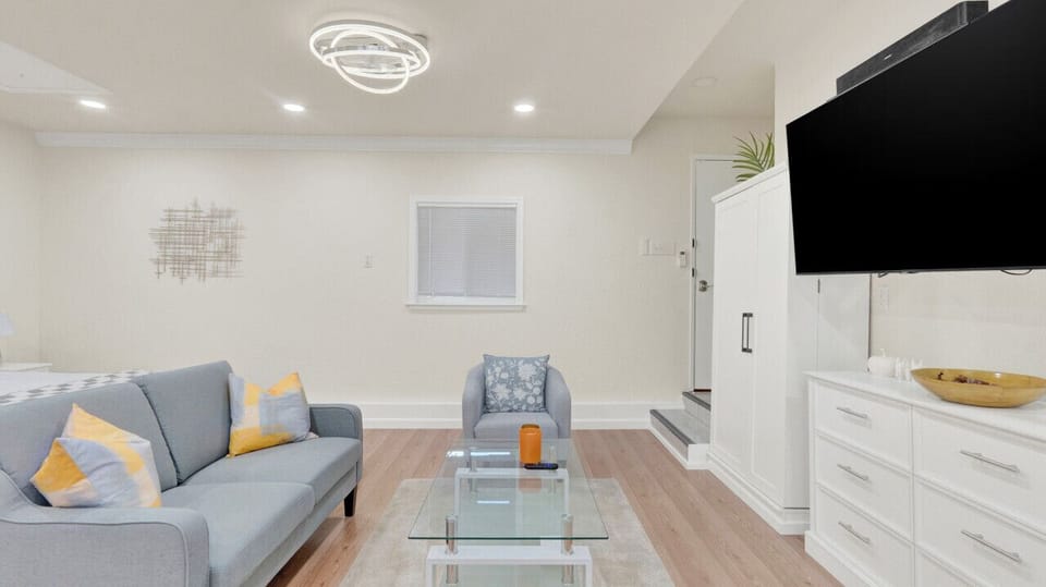 Inviting living area with a comfy sofa, modern decor, and a big-screen TV – perfect for unwinding after a day of exploring