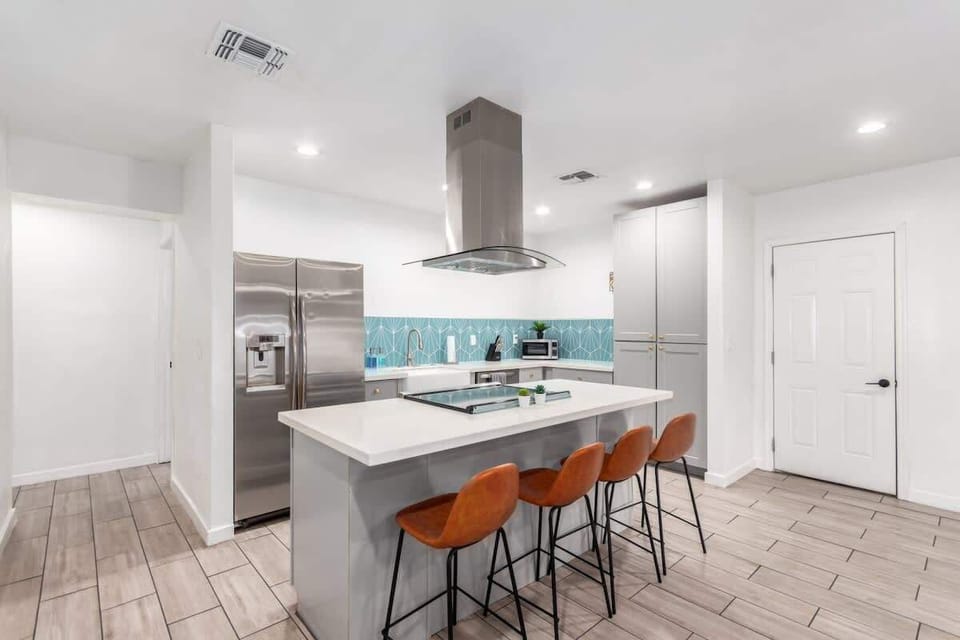 Cook and connect in the modern kitchen, featuring an elegant island and ample seating for family and friends.