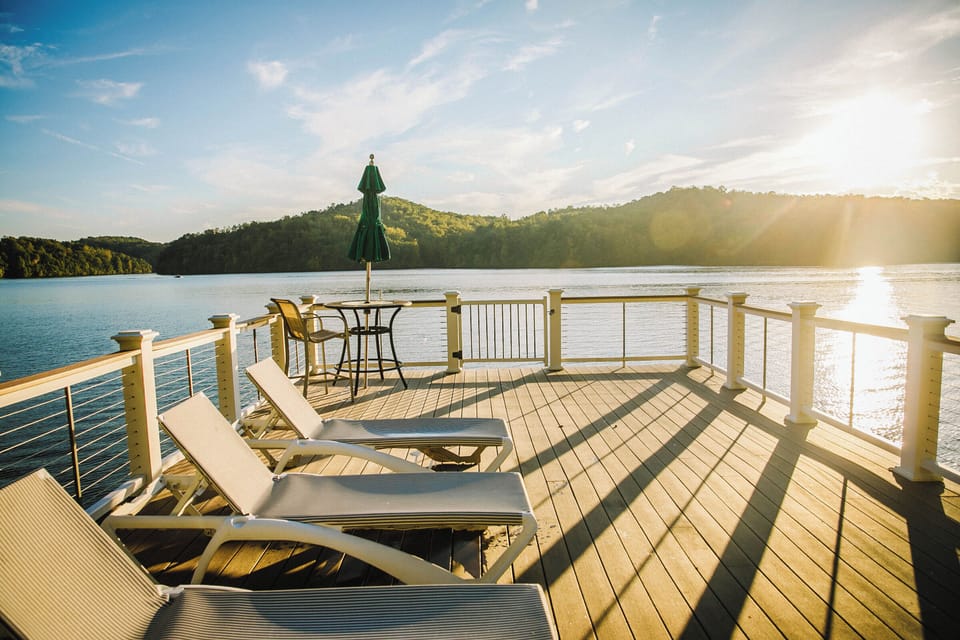 Spacious waterfront deck with lounge chairs and breathtaking views.