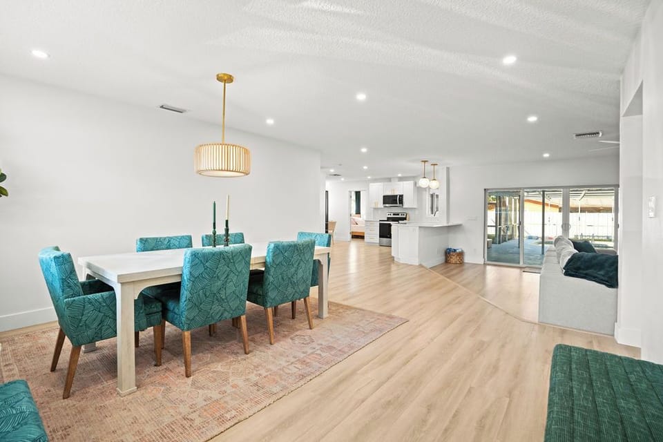 Experience the spaciousness of our open-concept design! ✨ This wide view showcases the seamless flow between the dining area, modern kitchen, and comfortable living room. 🏡