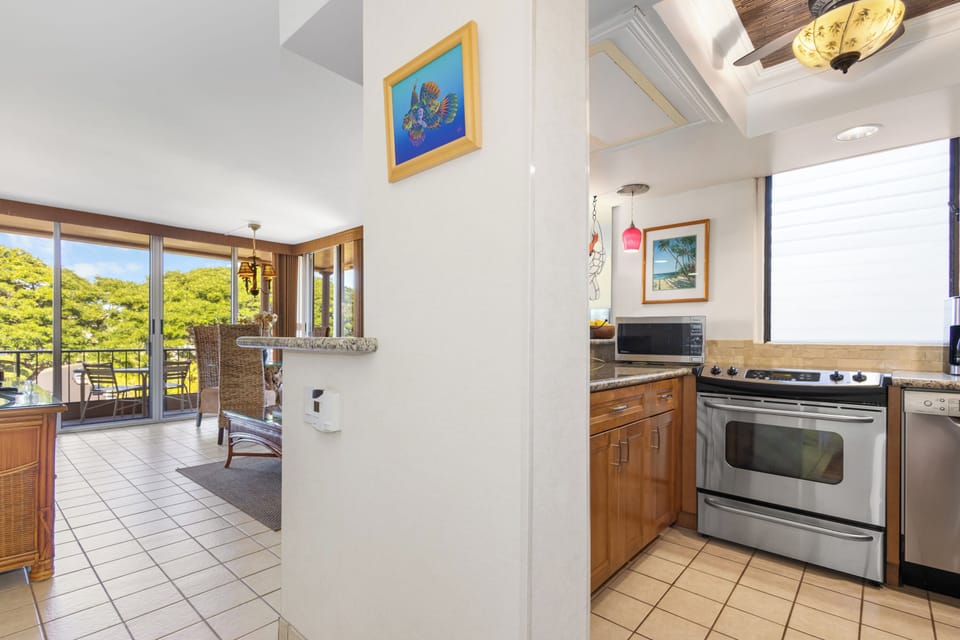 Open, sunlit living with a full kitchen and balcony access. Cook your favorite meals and step outside to enjoy the tropical breeze and lush greenery surrounding your retreat.