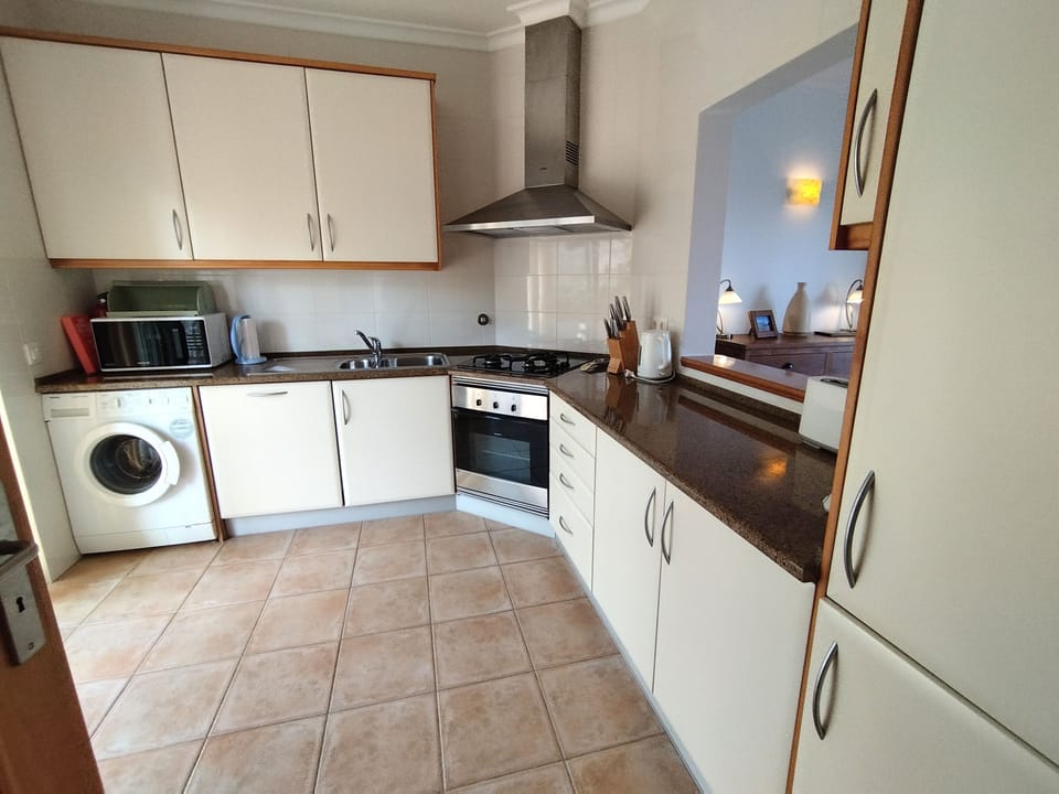 Well-equipped Kitchen, serving hatch to dining area and doors on left to patio