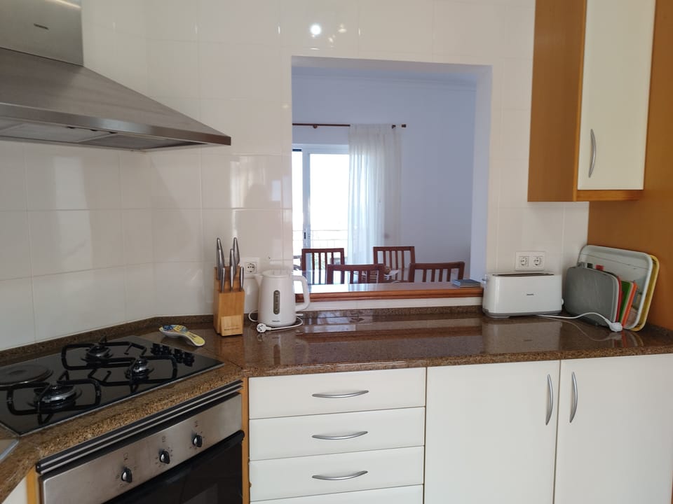 The kitchen and dining area are connected by a handy service hatch