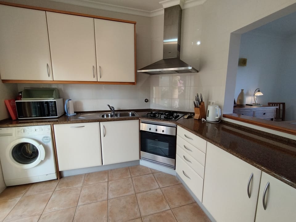 Well equipped kitchen, service hatch to dining area and doors to rear patio