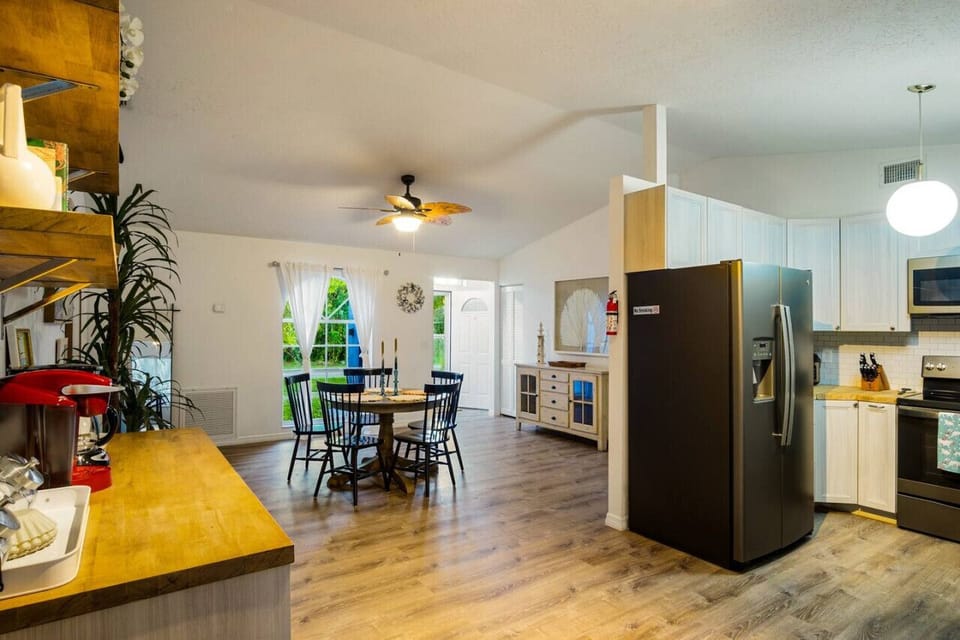 Open-concept kitchen and dining room with plenty of seating and natural light — great for entertaining.