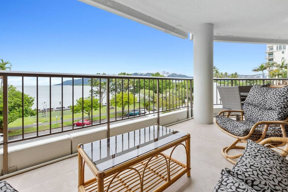 Charming private balcony with cozy seating, including a comfortable sofa and chairs, perfect for sipping your morning coffee or evening wine. Enjoy the tranquil views of the Esplanade and sea while relaxing in this peaceful outdoor retreat.
