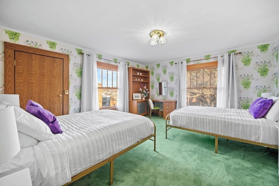 This Monet-inspired bedroom features two new, queen sized beds, floral accents, and gorgeous natural lighting!