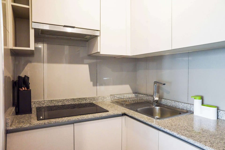 Modern and efficient kitchen with sleek countertops and essential amenities for a comfortable stay.